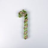 green glass candy cane ornaments on a white background
