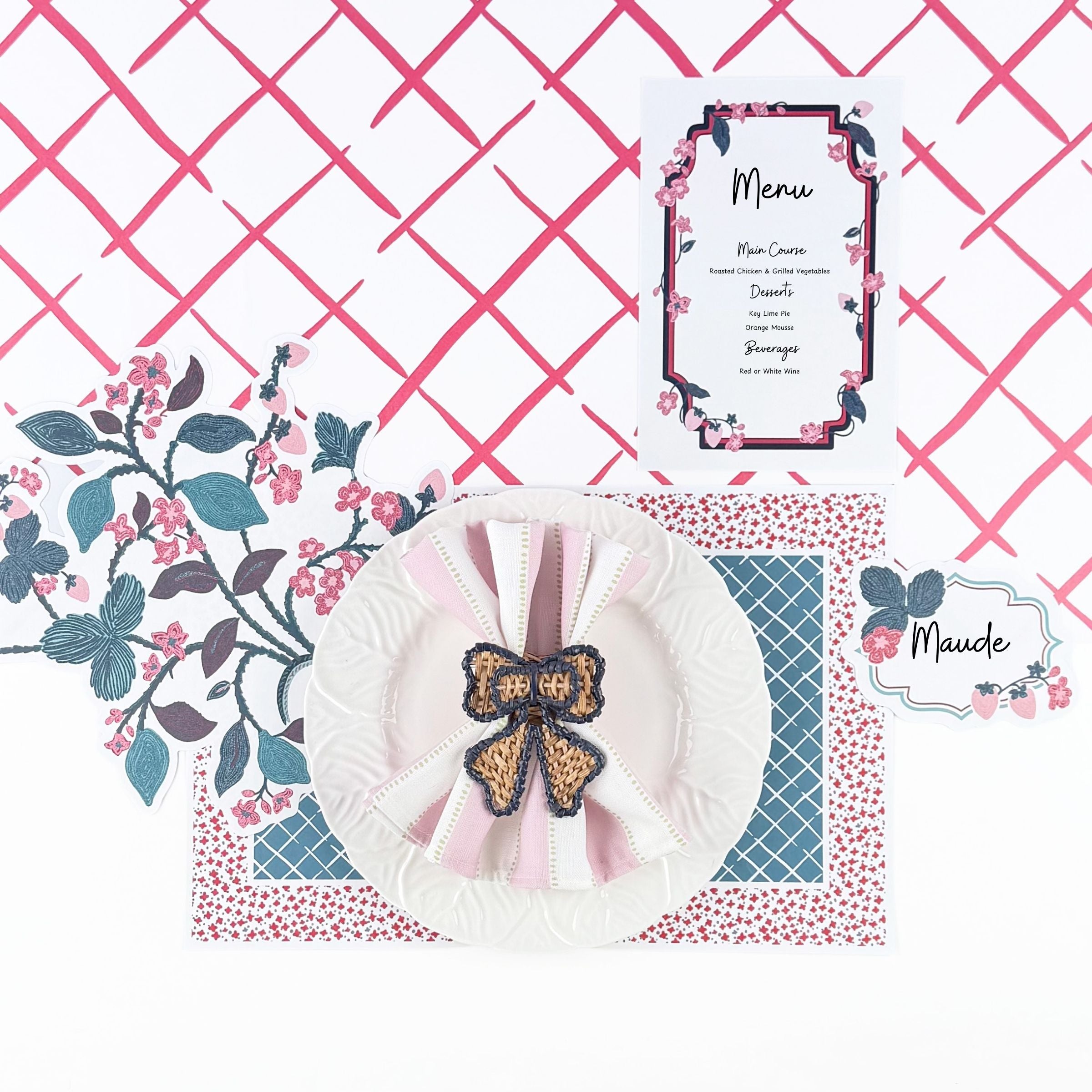 a strawberry place setting with a white plate, strawberry menu card, strawberry placemat, strawberry place card and a blue and red paper placemat