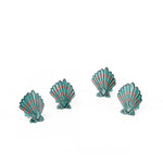 Blue and pink shell napkin rings featuring coastal-inspired seashell designs.