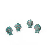 Blue and pink shell napkin rings featuring coastal-inspired seashell designs.