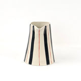 Blue and red striped pitcher front view with cream ceramic finish and hand painted vertical stripe pattern.