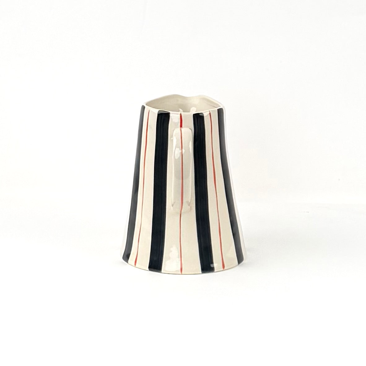 Blue and red striped pitcher handle view with cream ceramic finish and hand painted stripe details.