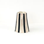 Blue and red striped pitcher handle view with cream ceramic finish and hand painted stripe details.