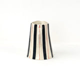 Blue and red striped pitcher handle view with cream ceramic finish and hand painted stripe details.