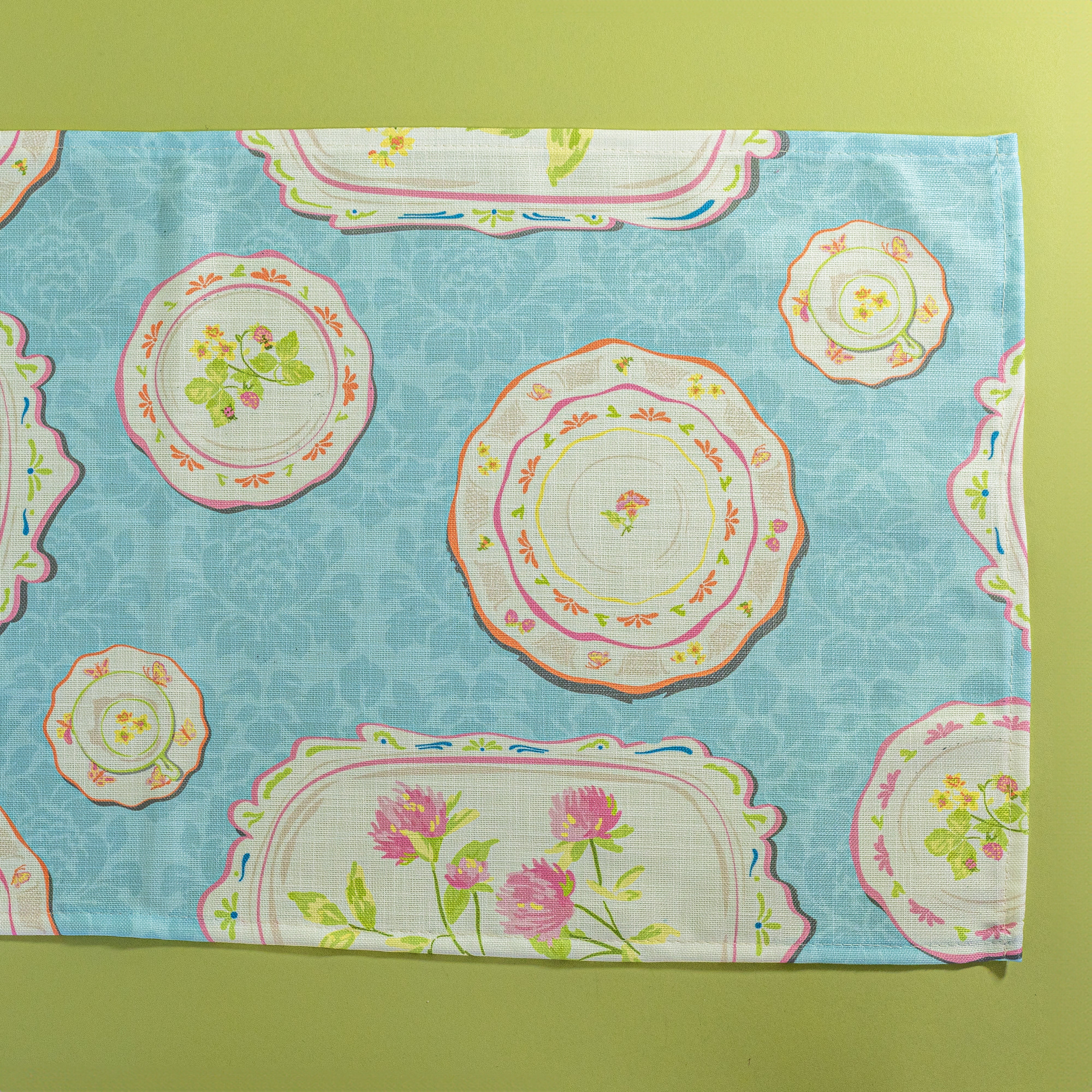 Society Hill Vintage Plates cloth table runner close-up in blue on a green background
