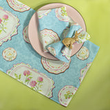 blue society hill vintage plates cloth table runner and napkins with a pink plate and bunny napkin rings on a green background.