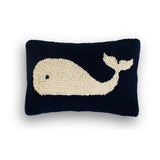 a blue and white whale pillow against a white background