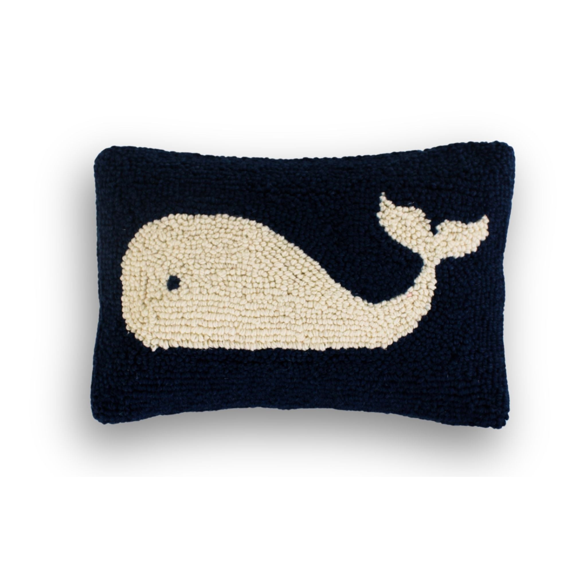 a blue and white whale pillow against a white background