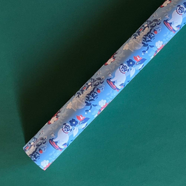 Blue christmas wrapping paper with a repeated pug and floral motif