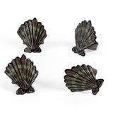 Four brown and green shell shaped napkin rings 