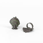 Pair of brown and green shell napkin rings featuring coastal-inspired seashell design.