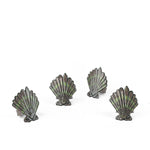 Brown and green shell napkin rings featuring coastal-inspired seashell designs.