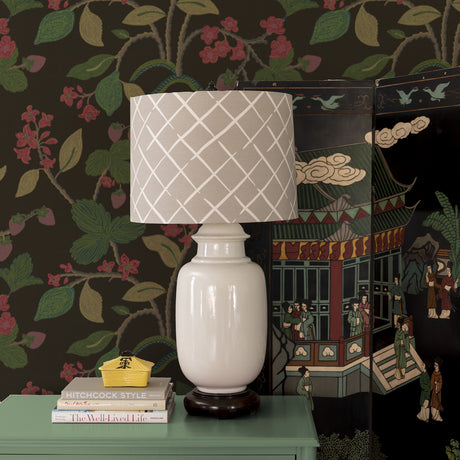 beige lamp against patterned lemon and strawberry wallpaper