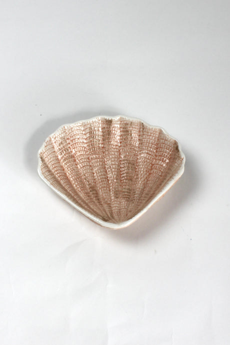 A small brown ceramic shell bowl