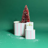 duo of Cabana Boy caddies in large and small on a green bakground with a notepad and faux tree in them