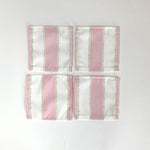 A set of four Cabana Boy white and pink stripe cloth cocktail napkins in a linen-like poly