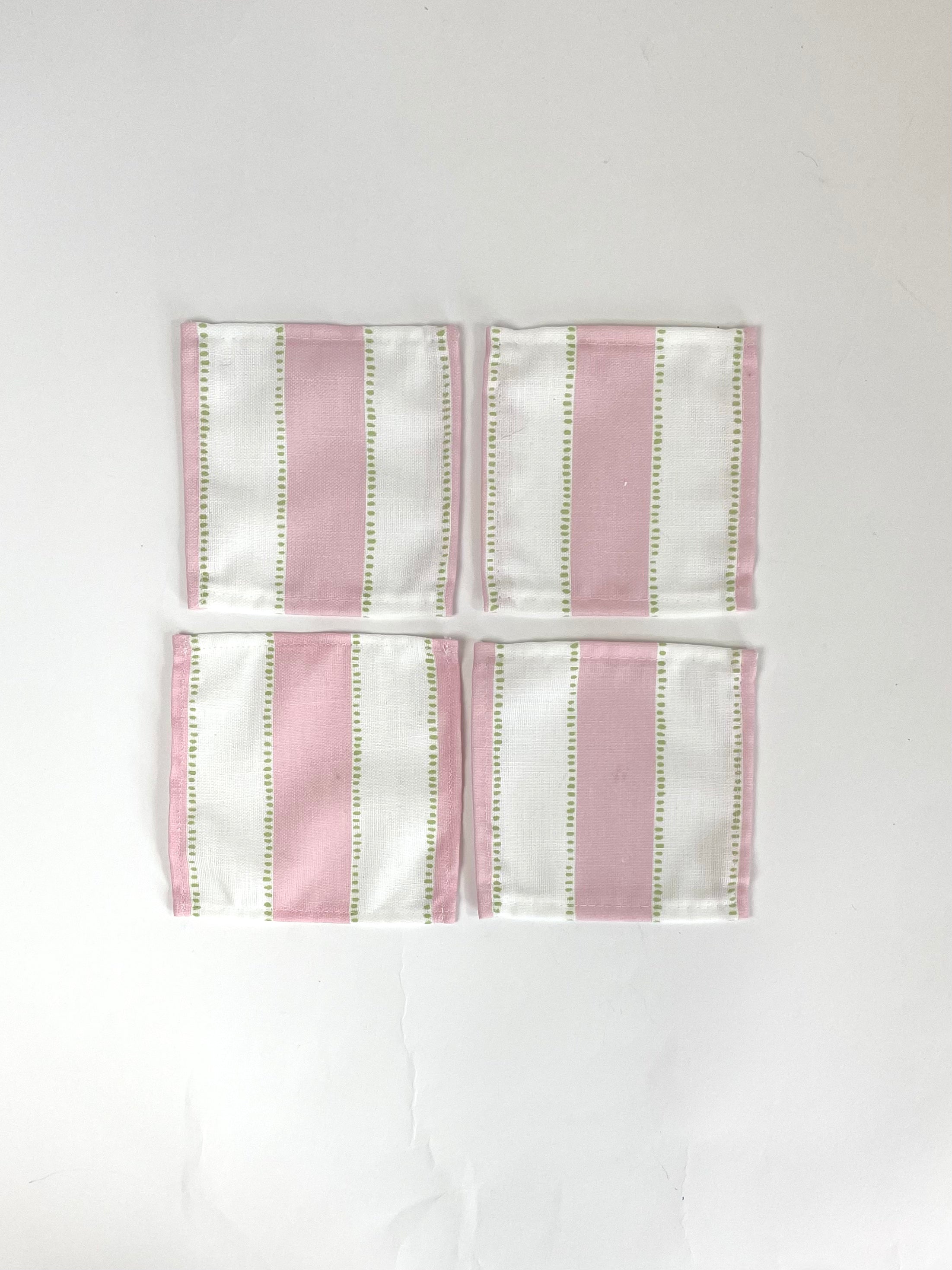 A set of four Cabana Boy white and pink stripe cloth cocktail napkins in a linen-like poly