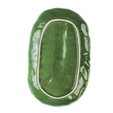 back of a large ceramic cabbage serving platter with white background