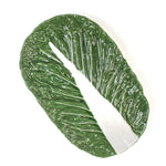 top view of a a large ceramic cabbage serving platter with white background