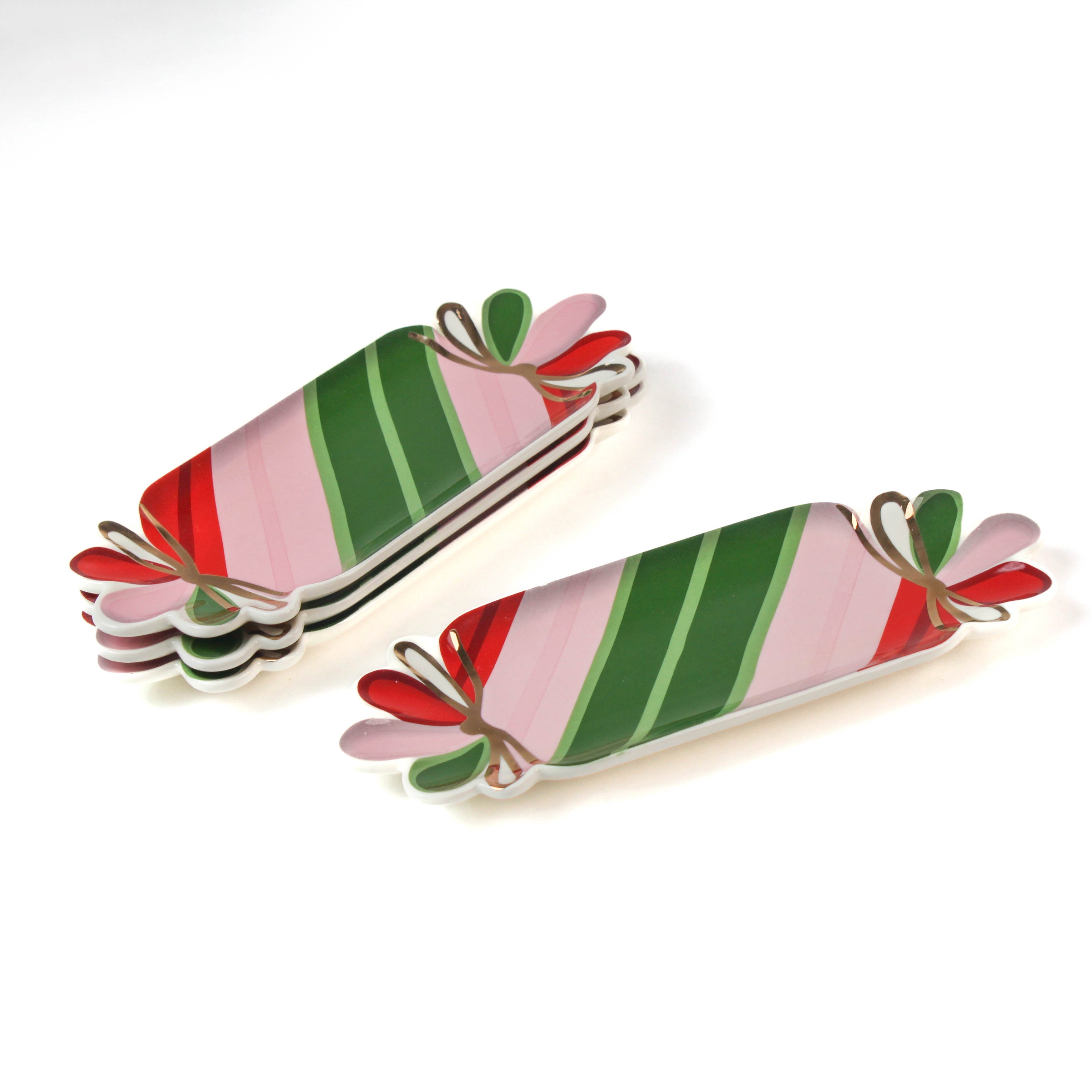 four striped ceramic accent plates with candy motifs on a white surface