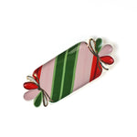 top view of a striped ceramic accent plates with candy motifs on a white surface