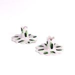 Set of two white ceramic scalloped candle holders with hand-painted green brushstroke accents, designed for taper candles, displayed on a white background.