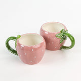2 pink Ceramic Strawberry Mugs with green handler in a white background, showing the top view