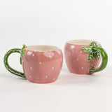 2 pink Ceramic Strawberry Mug with green handler in a white background