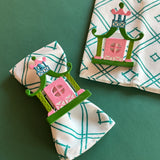 Chinoiserie Pagoda Painted-Metal Napkin Rings with one on a green and white dinner napkin