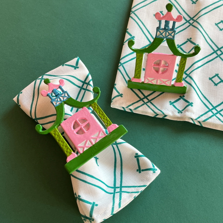 Chinoiserie Pagoda Painted-Metal Napkin Rings with one on a green and white dinner napkin