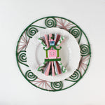 Chinoiserie Pagoda Painted-Metal Napkin Rings with one on a pink, green and white plate dinner napkin