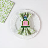 Chinoiserie Pagoda Painted-Metal Napkin Rings with one on a green and white plate dinner napkin