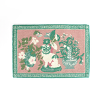 A green and pink rug with a green pug motif and a green geometric border