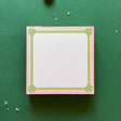 square notepad with green decorative borders, displayed on a green background
