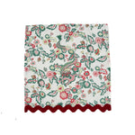 floral and dragon-pattern dinner napkin with red scalloped trim