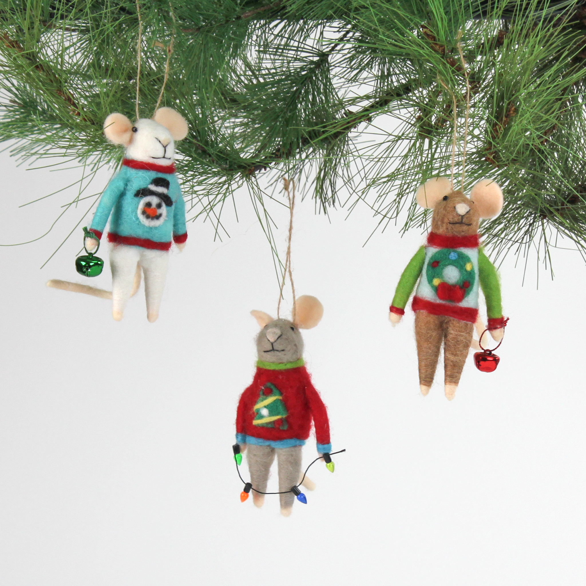 Three felt mouse ornaments dressed in colorful holiday sweaters—one with a snowman, one with a wreath, and one with a Christmas tree—each holding a gift.