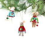 Three felt mouse ornaments dressed in colorful holiday sweaters—one with a snowman, one with a wreath, and one with a Christmas tree—each holding a gift.