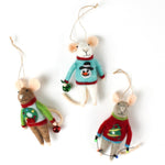 Three felt mouse ornaments dressed in colorful holiday sweaters—one with a snowman, one with a wreath, and one with a Christmas tree—each holding a gift.