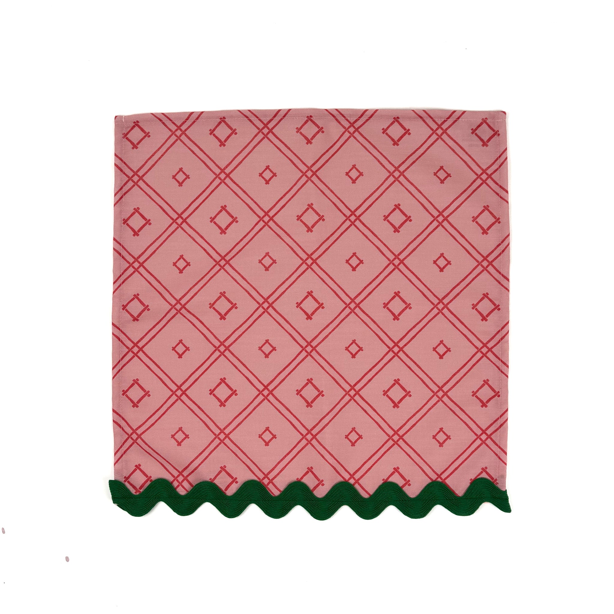 red lattice-pattern dinner napkin with green scalloped trim