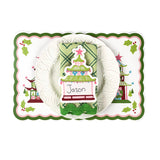 Holiday table setting featuring a Christmas pagoda decorative placemat, white ruffled plate, green patterned napkin, and pagoda-shaped paper place card with handwritten name, arranged on a white background.