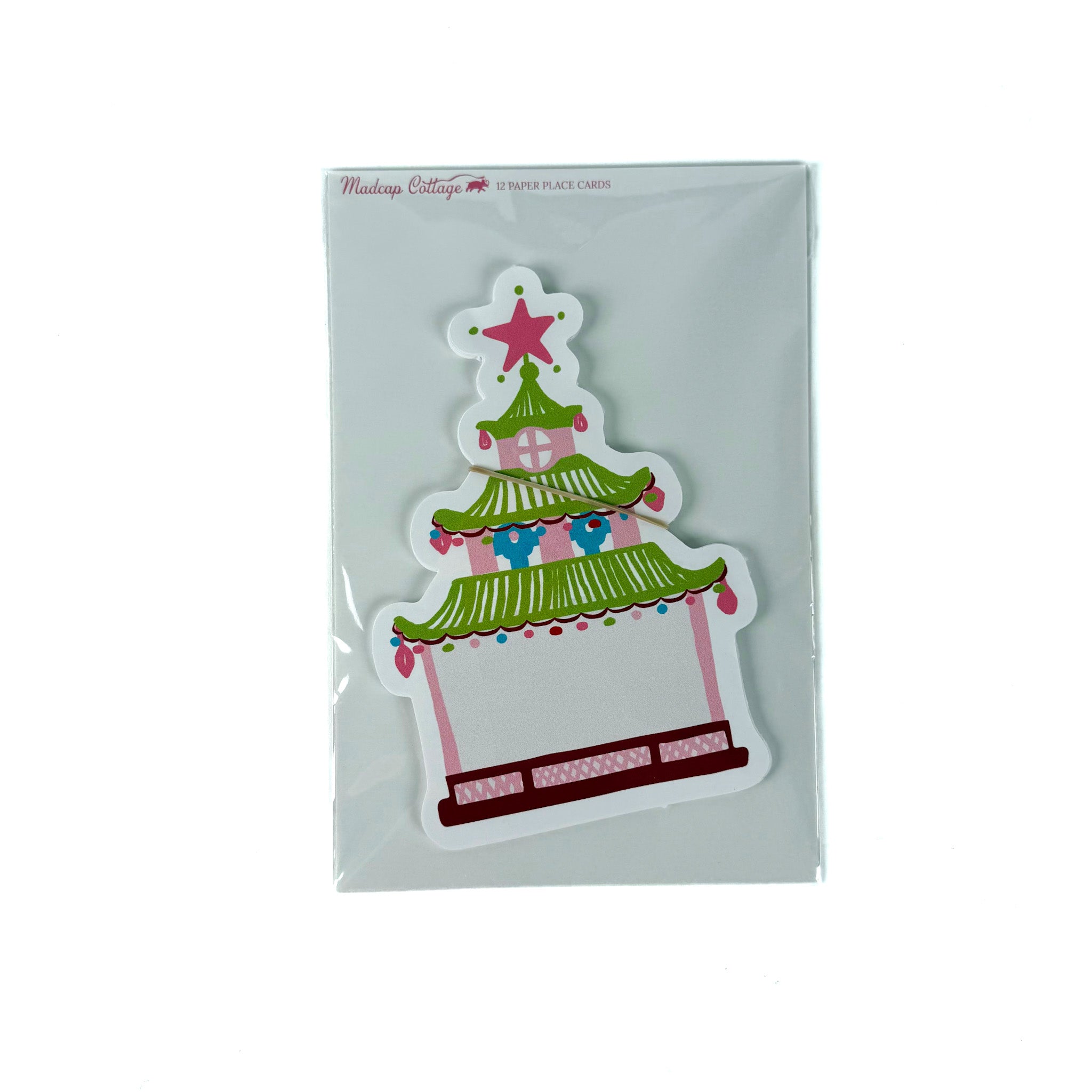 Pack of pagoda-shaped Christmas paper place cards with green roof, pink accents, and star topper, shown in clear packaging on a white background.