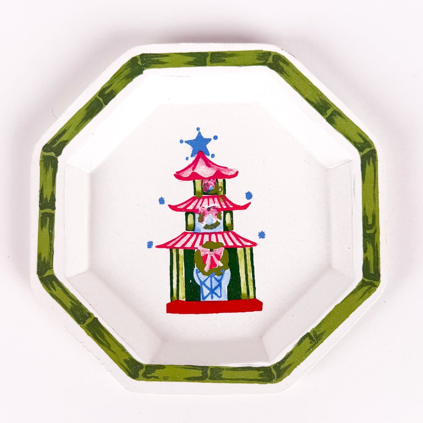 octagon-shaped tray with a green border and a painted Christmas pagoda design featuring pink and blue accents