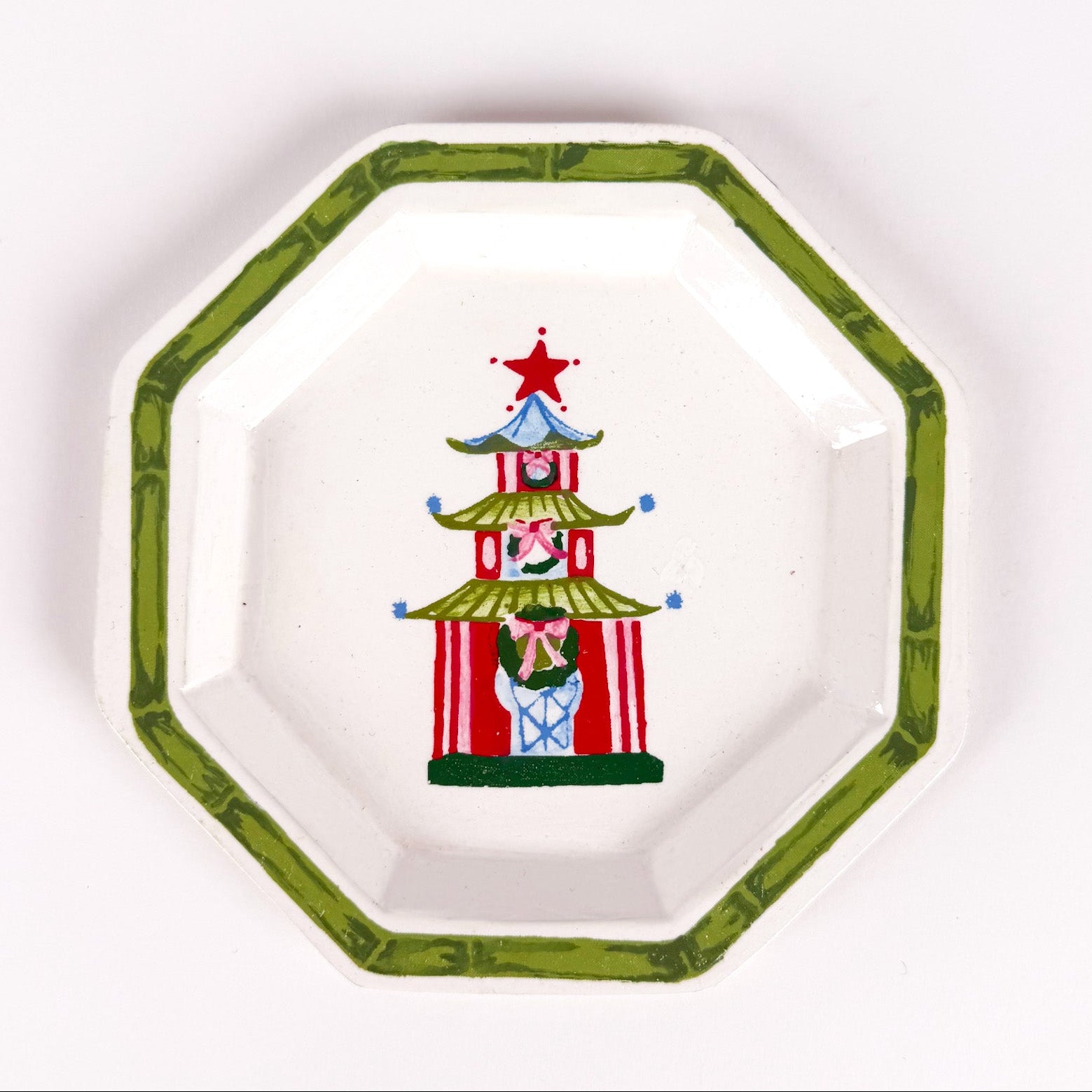 octagon-shaped tray with a green border and a painted red and green Christmas pagoda design