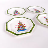 set of octagon-shaped trays with green borders and colorful painted Christmas pagoda designs