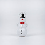 snowman ornament with a top hat, red bow tie, and black buttons on a white background