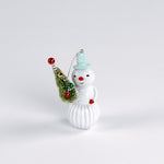 Decorative snowman ornament with a small tree on a white background