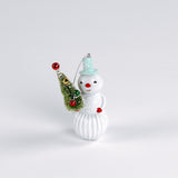 Decorative snowman ornament with a small tree on a white background