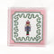 medium Nutcracker Square Acrylic Tray with pink and green border and Nutcracker in the center.