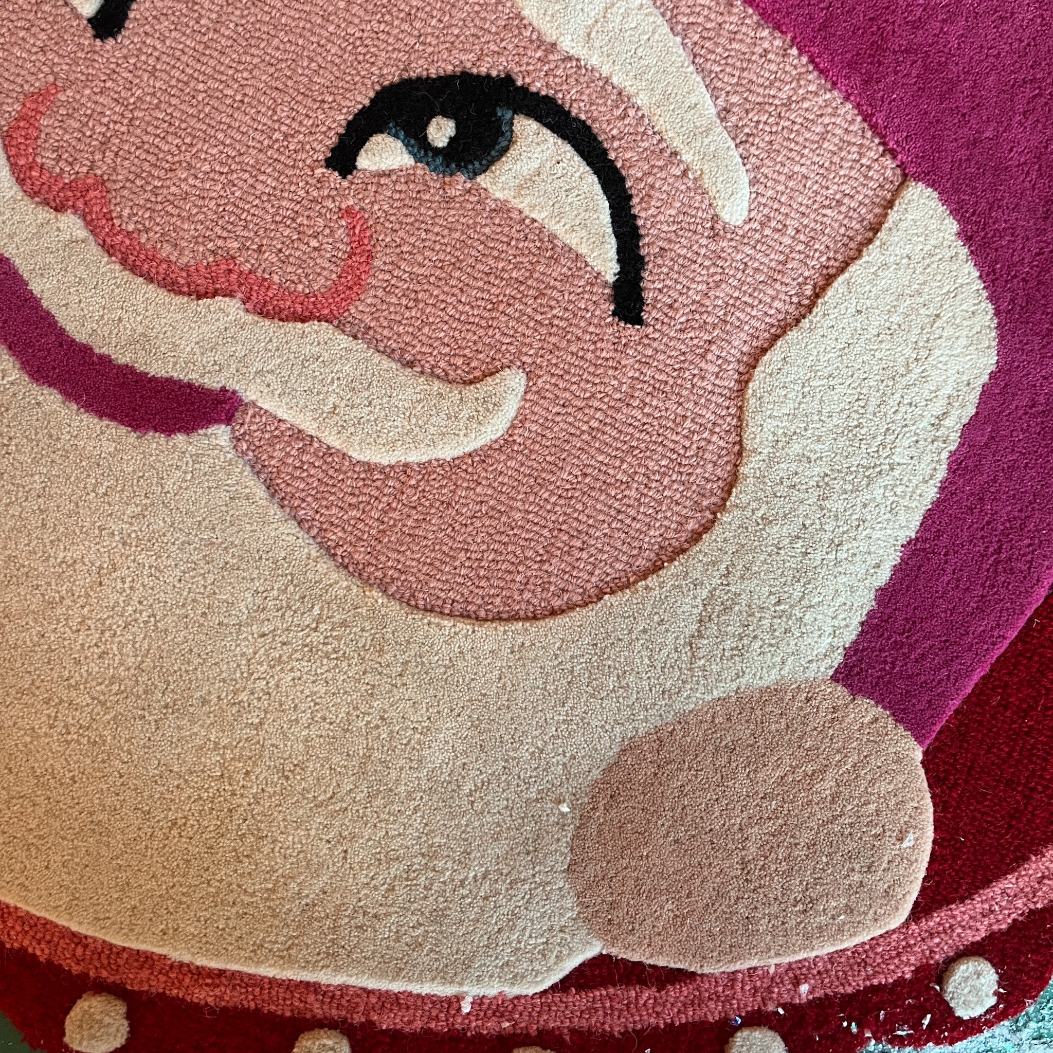 close up oval Christmas rug featuring a large santa face