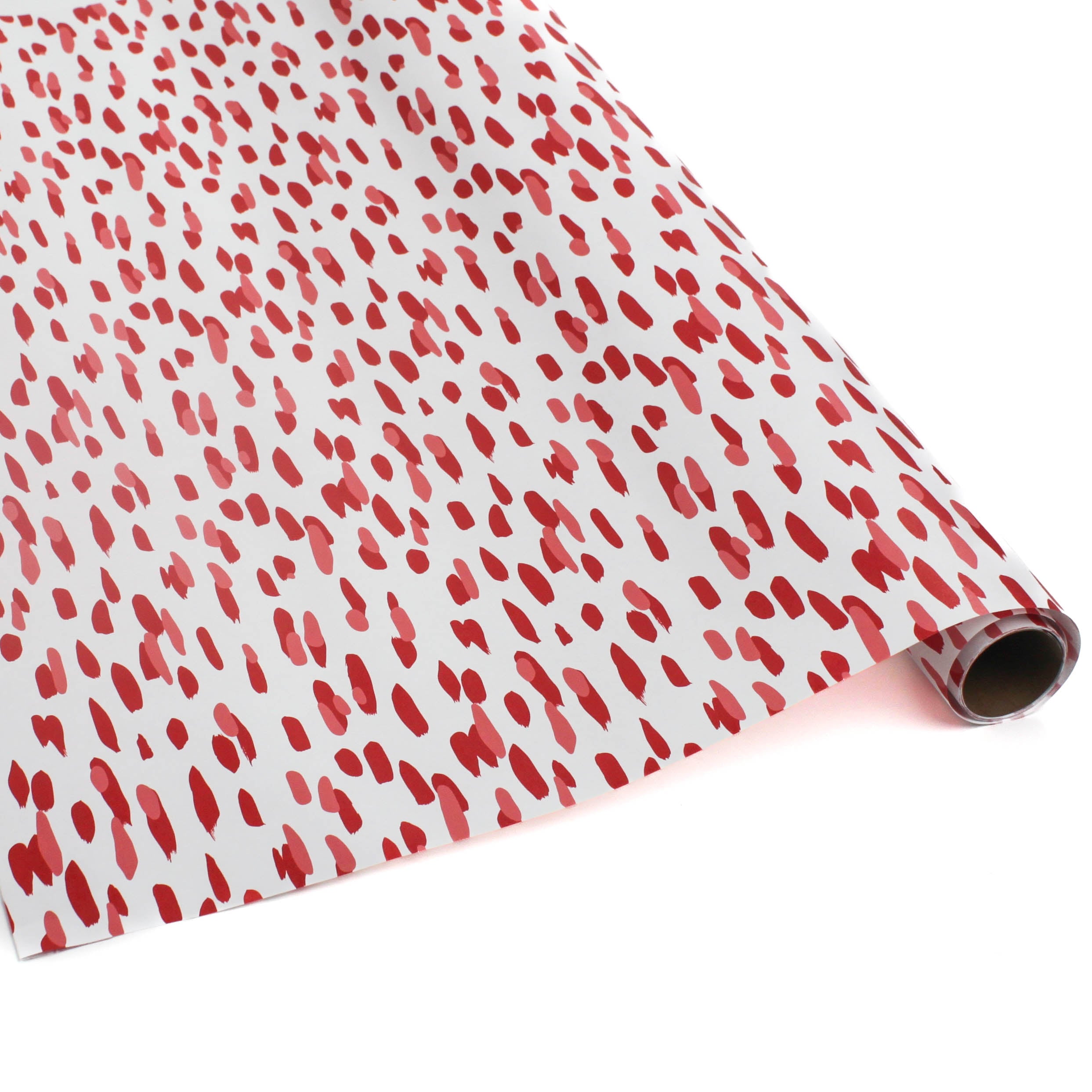 A roll of wrapping paper in painterly patterns and red in color.